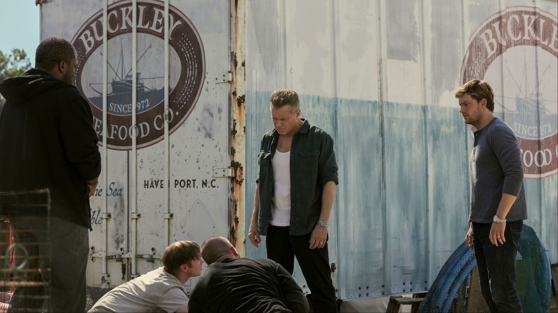 In The Waterfront, the Buckley family's seafood business masks their darker dealings, as shown in this tense moment outside the Havenport dock. (Image via Netflix)